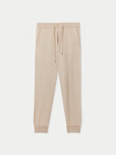 A pair of beige cashmere men's joggers with ribbed trims and an adjustable waistband with drawstrings. #color_beige