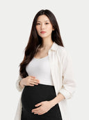 close up of Woman wearing a white shirt and black maternity pants on a white background  #color_black
