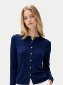 Woman wearing a navy blue cardigan on a light gray background #color_mood-indigo