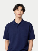 Man wearing a navy blue polo shirt against a white background #color_navy