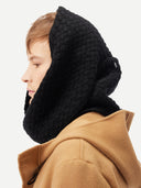 side view of a person wearing a black knitted hood and brown coat on a white background #color_black