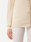 close up of a white V-neck cardigan and pants #color_off-white
