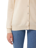 close up of a white cardigan and blue jeans  #color_off-white