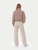 back view of a pink puffer jacket and beige pants on a white background #color_taupe