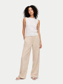 front view of a white sleeveless top and beige wide-leg pants on a white background #color_whisper-white