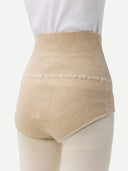close up back view of woman wearing white top and beige underwear with white tights  #color_taupe #color_beige