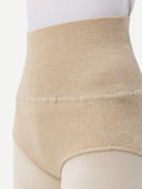 close up front view of woman wearing white top and beige underwear with white tights #color_beige