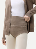 close up of a taupe colored cardigan matching high waist underwear over white tight on a light gray background #color_taupe