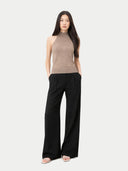 Woman wearing a brown sleeveless top and black wide-leg pants on a white background #color_taupe