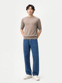 front view of a man wearing a beige sweater and blue jeans on a white background #color_timber-wolf
