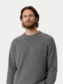 Man wearing a gray sweater against a white background #color_dim-gray