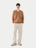 front view of a man wearing a brown sweater and white pants on a white background #color_sheepskin