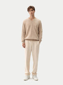 front view of a man wearing a beige sweater and pants on a white background #color_warm-grey