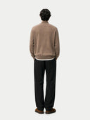 back view of a man wearing a brown cardigan and black pants on a white background #color_taupe