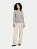 front view of a woman wearing a gray sweater and beige pants on a white background #color_high-rise