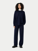 Person wearing a navy blue outfit on a white background #color_navy