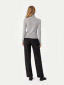 back view of a person wearing a gray turtleneck and black pants on a white background  #color_high-rise