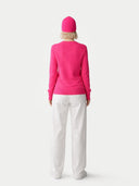 Person wearing a bright pink outfit with a matching hat on a white background #color_magenta