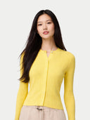 Woman wearing a yellow ribbed sweater against a white background #color_blazzing-yellow