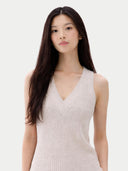Woman wearing a light-colored sleeveless top against a plain background #color_lavender-blue