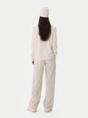 back view of Person wearing a beige outfit with a white background #color_off-white