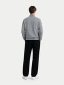 back view of a person wearing a gray sweater and black pants on a white background  #color_dim-gray
