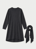 A dark gray long-sleeve knit dress with an asymmetrical hem, shown next to a matching dark brown scarf on a light gray background.