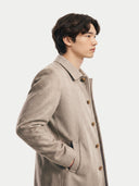 Model wearing the Natural Color Single-Breasted Cashmere Coat in Taupe, three-quarter side view