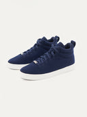 A pair of navy blue high-top cashmere sneakers with white soles. #color_navy
