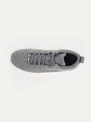 A top-down view of a gray sneaker with a textured knit upper and matching black laces. all set against a white background. #color_stone-gray