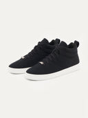 A pair of black high-top cashmere sneakers with white soles. #color_black
