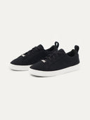A pair of black low-top cashmere ankle sneakers with lace-up closure. #color_black
