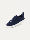 A side profile view of a navy low-ankle sneaker with a textured knit upper and navy laces, featuring a thick white rubber sole and a pull tab at the heel. #color_navy