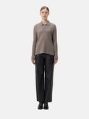 front view - woman wearing a light brown polo sweater and black pants #color_stucco