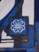Close-up of a patterned fabric with a logo and 'Gobi' branding. #color_india-ink