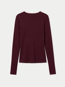 A long-sleeve crewneck knit top in a deep burgundy color, displayed flat against a light gray background.