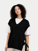 Woman wearing a black and white top with a plain background #color_black