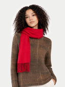 Woman wearing a red scarf and brown sweater on a white background #color_barberry