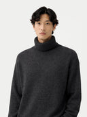 Man wearing a dark gray turtleneck sweater on a white background #color_charcoal