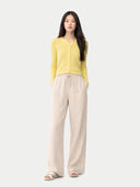 front view of a yellow cardigan and beige pants on a white background #color_blazzing-yellow