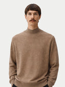 Man wearing a brown turtleneck sweater against a plain background #color_taupe