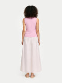 back view of a pink top and white skirt on a white background #color_almond-blossom