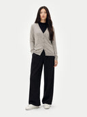 Woman wearing a light gray cardigan over a black top with black pants on a white background #color_dawn-blue
