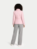 Back view of a person wearing a pink quilted jacket and gray pants on a white background #color_potpourri