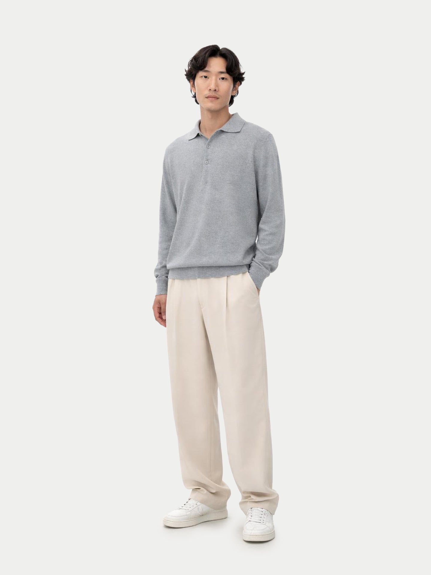 Man wearing a gray sweater and beige pants on a white background #color_vapor-blue
