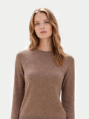 Woman wearing a brown sweater against a white background #color_taupe