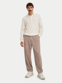 front view of a Man wearing a white polo sweater and beige pants on a white background #color_marshmallow