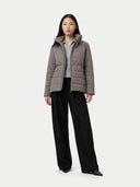 Person wearing a gray puffer jacket and black pants on a white background #color_dim-gray