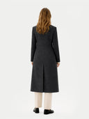 back view of a person wearing a long dark coat on a white background #color_charcoal