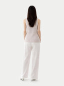 back view of a sleeveless top and white pants on a plain background #color_lavender-blue